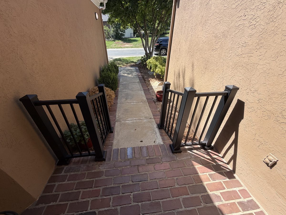 Handrails on a set of brick front steps viewed from above
